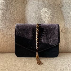Velvet crossbody bag in black with gold chain.